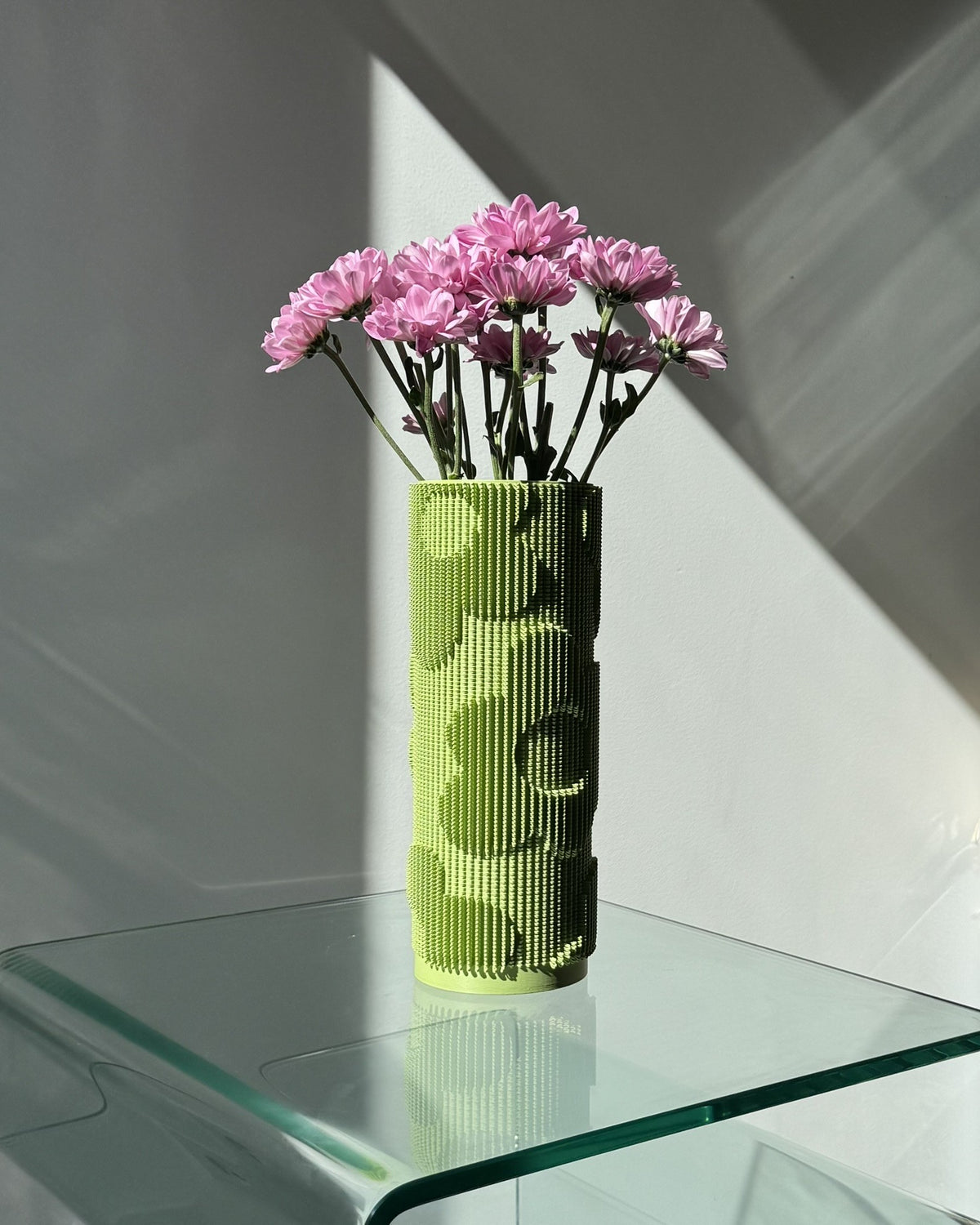 Design vase in green with floral relief texture on neutral background
